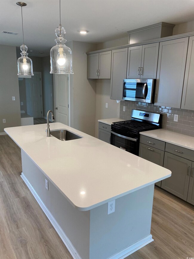 Kitchen featuring decorative backsplash, range wit