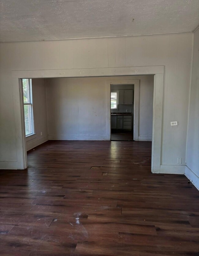 living area featuring a textured ceiling, a health