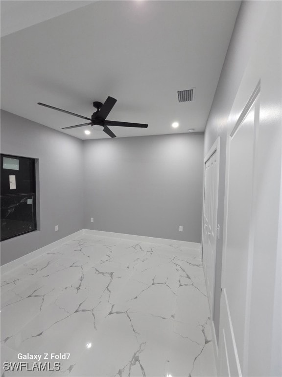 Empty room with marble finish flooring, recessed lighting, and a ceiling fan