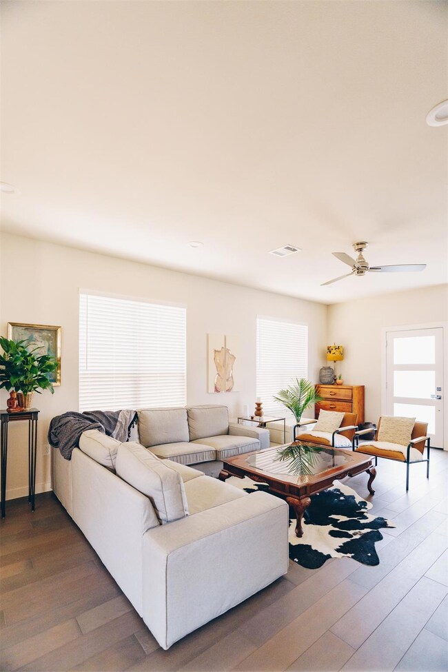 Living area featuring ceiling fan, wood finished 