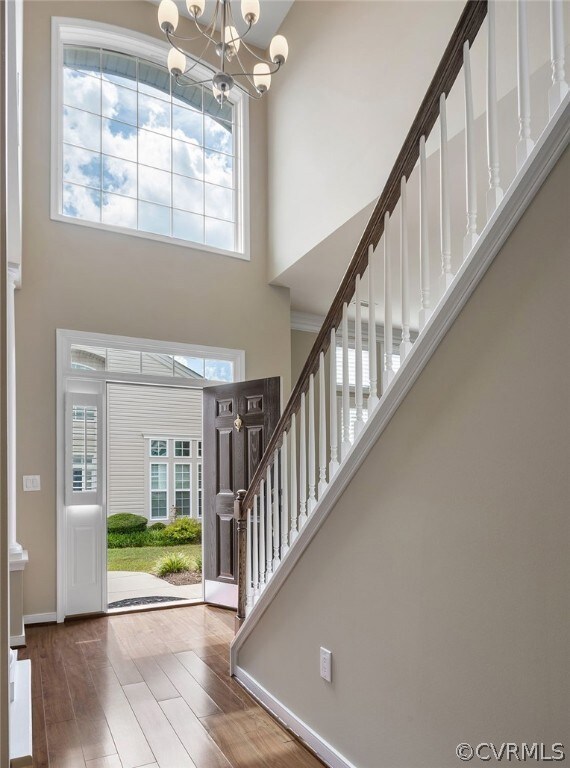  2 Story Foyer featuring a high ceiling, an inviti