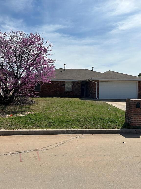 Single story home with a garage, driveway, a front