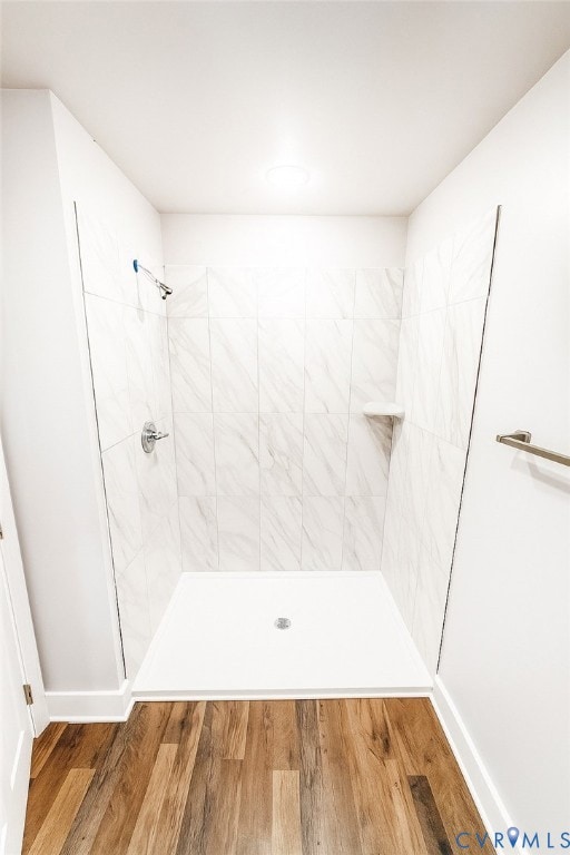 Full bathroom with a stall shower and wood finished floors