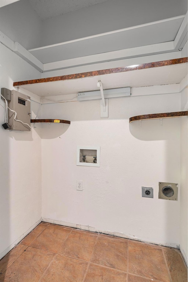 Laundry room featuring electric dryer hookup, wash