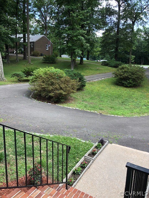The circular drive blooms with azaleas in the spri