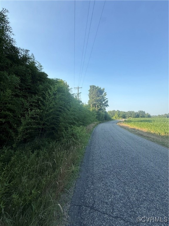 View of asphalt street featuring a rural view and