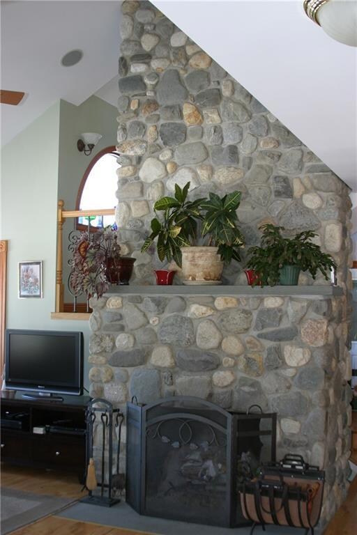 Custom field stone fireplace adds...