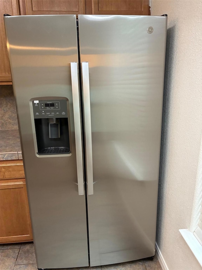 Room details with dark countertops, brown cabinet