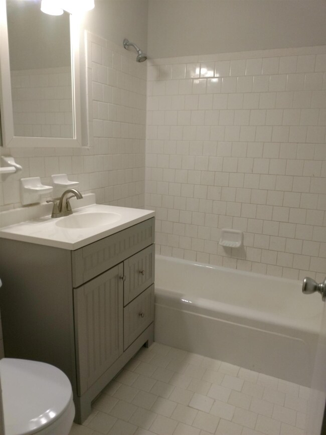 Hall bath with new tile and cabinet