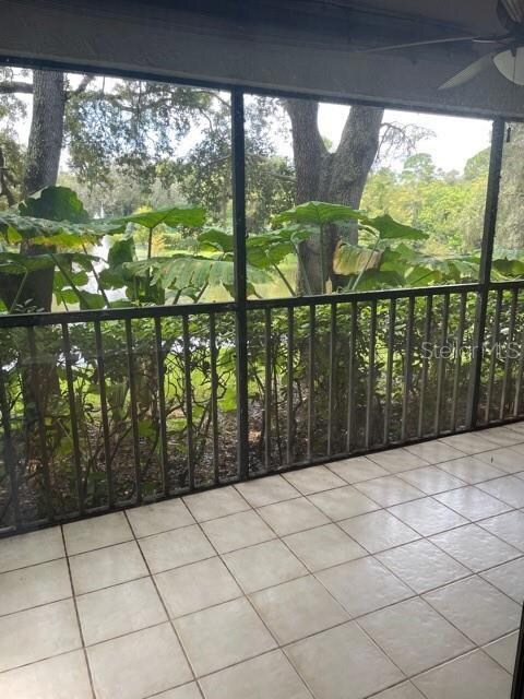 Rear Screened Porch overlooking Pond with Tropical Foliage