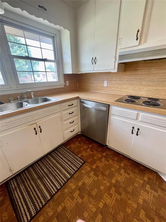 Kitchen featuring white cabinets, dishwasher, back