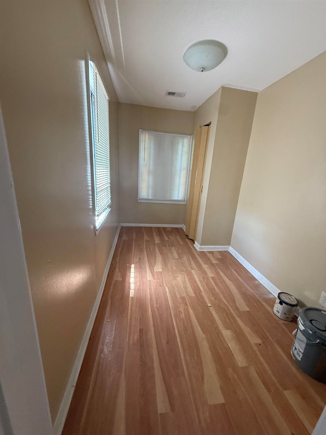 Empty room featuring baseboards and wood finished floors
