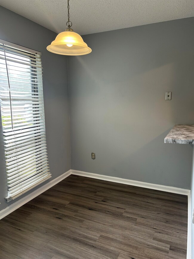 Empty room with dark wood-type flooring, a texture