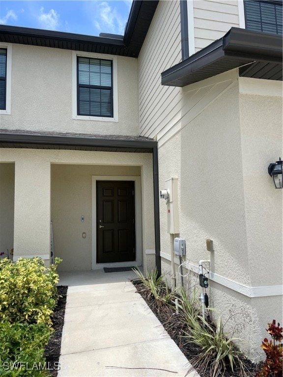 View of exterior entry with stucco siding