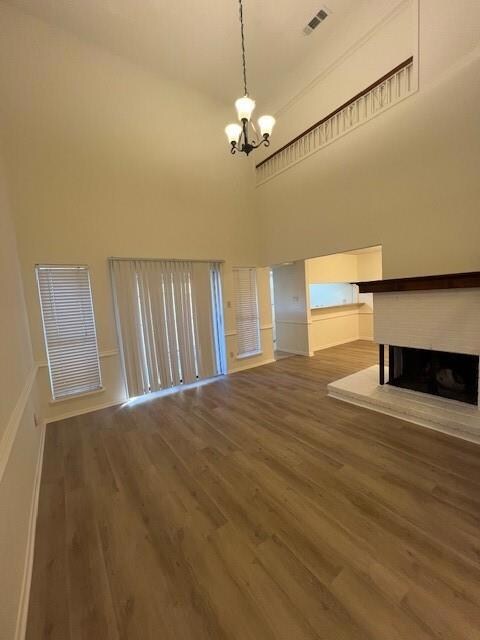 Unfurnished living room with a brick fireplace, vi
