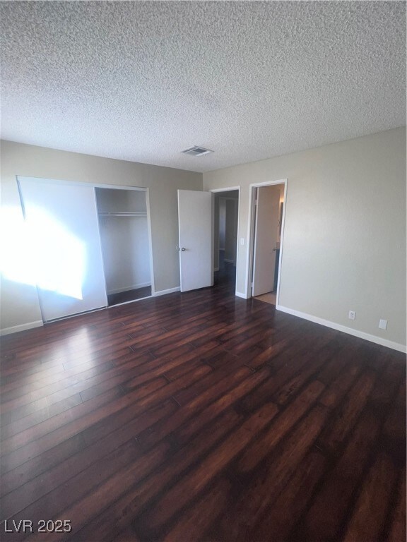 Unfurnished bedroom featuring a textured ceiling,