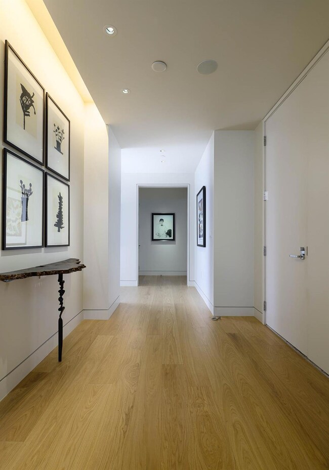 Entry featuring baseboards, light wood-s floors, a