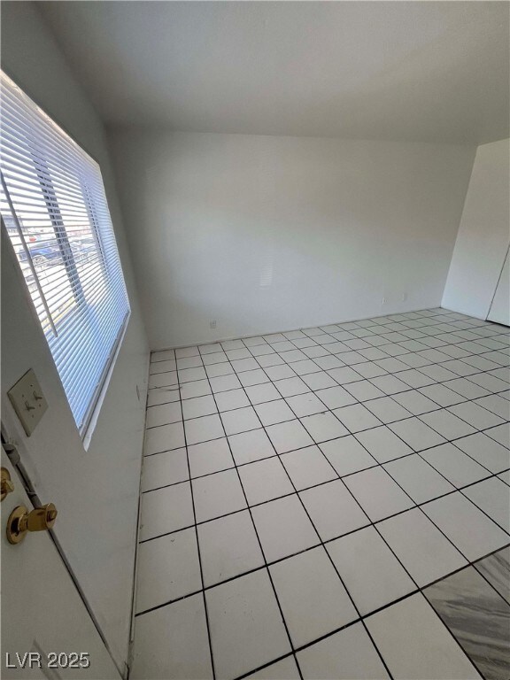 Empty room with light tile patterned floors