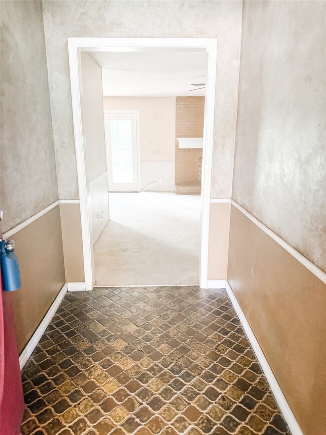 Hall with stone finish floors and carpet