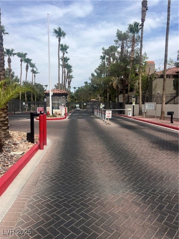 View of decorative street with curbs, a gated entry, and a gate