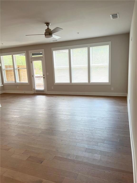 Empty room with a ceiling fan, baseboards, visible