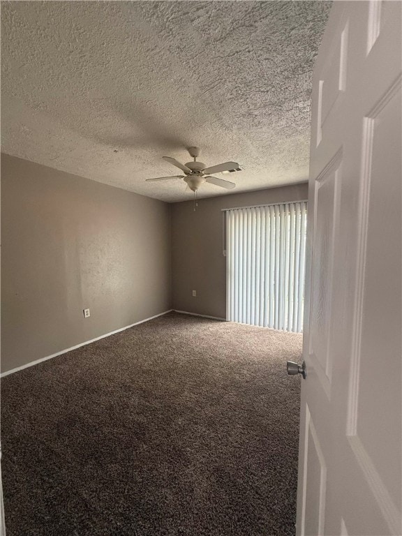 Carpeted spare room featuring ceiling fan and a te