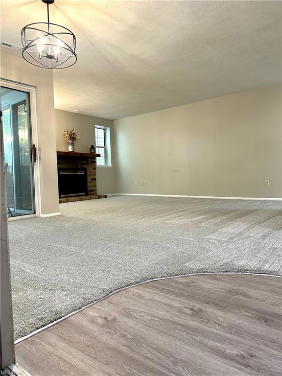 Living room with light carpet, a fireplace, and a 