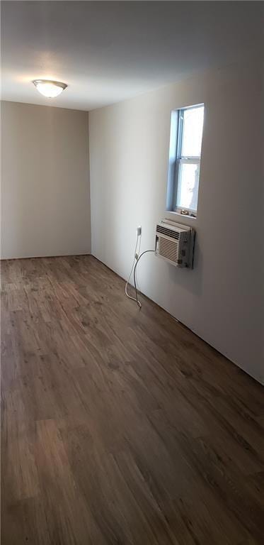 Unfurnished room with a wall mounted AC and wood 