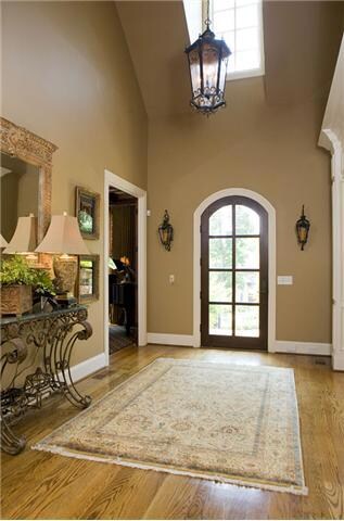 The two story foyer features hardwood flooring as does the rest of the main level of the home and opens to the dining area and library. It features beautiful updated lighting and is a focal point as you enter or leave the home.