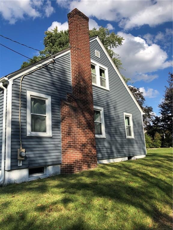 Right side view of home with new siding and window