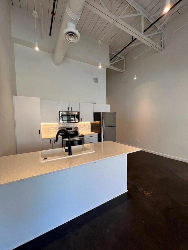 Kitchen with a high ceiling, stainless steel appli