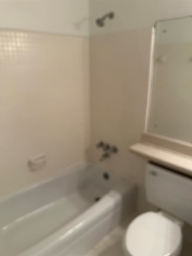 Full bath with toilet and  shower combination