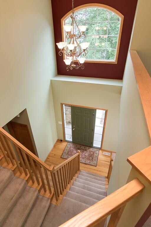 Two story entry has hardwood floors and a convenie