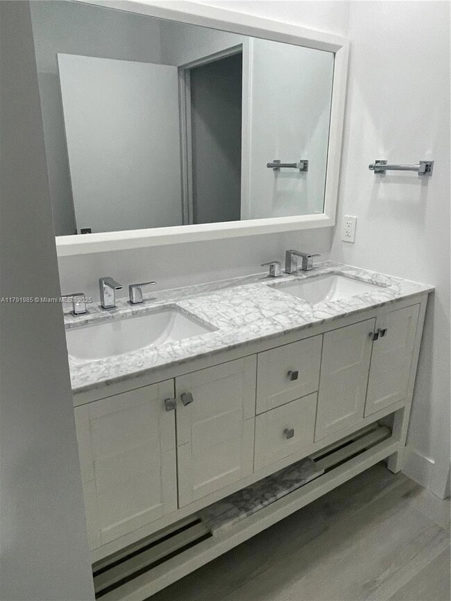Master vanity with double sinks and marble countertop.