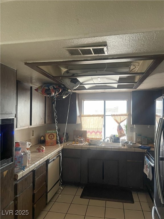 Kitchen with tile countertops, stainless steel app