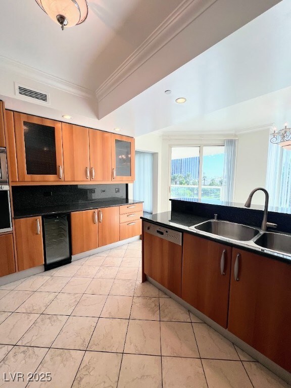 Kitchen featuring ornamental molding, a sink, appl