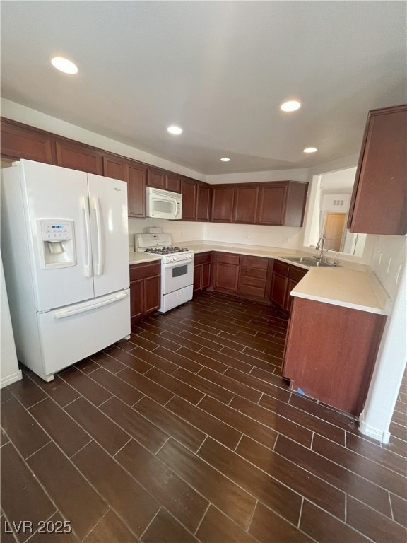 Kitchen featuring white appliances, light countert