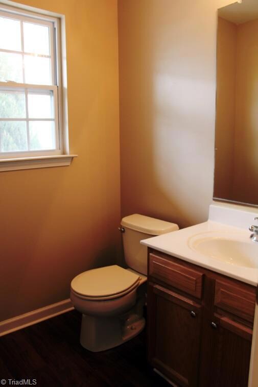 Half Bath in Foyer freshly painted and laminate wood flooring.