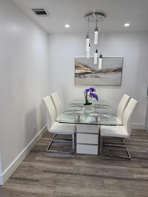 Dining room with recessed lighting and wood finis