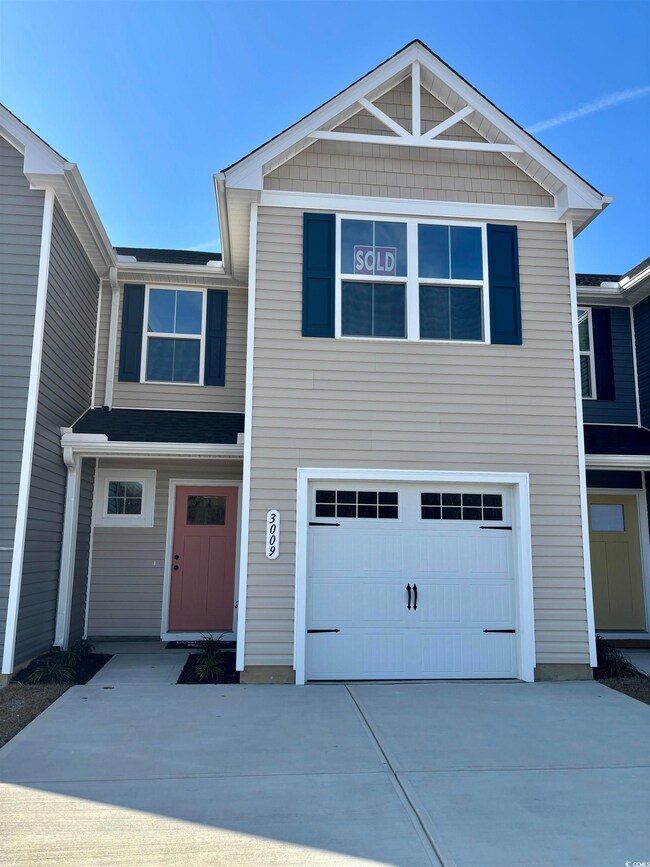 View of front of property with a garage