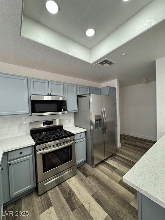 Kitchen with stainless steel appliances, visible v