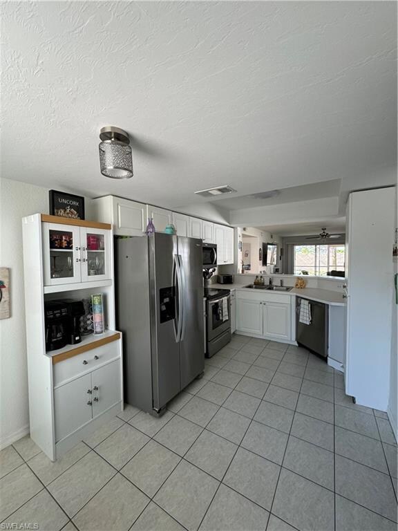 Kitchen featuring dishwasher, stove, freestanding 