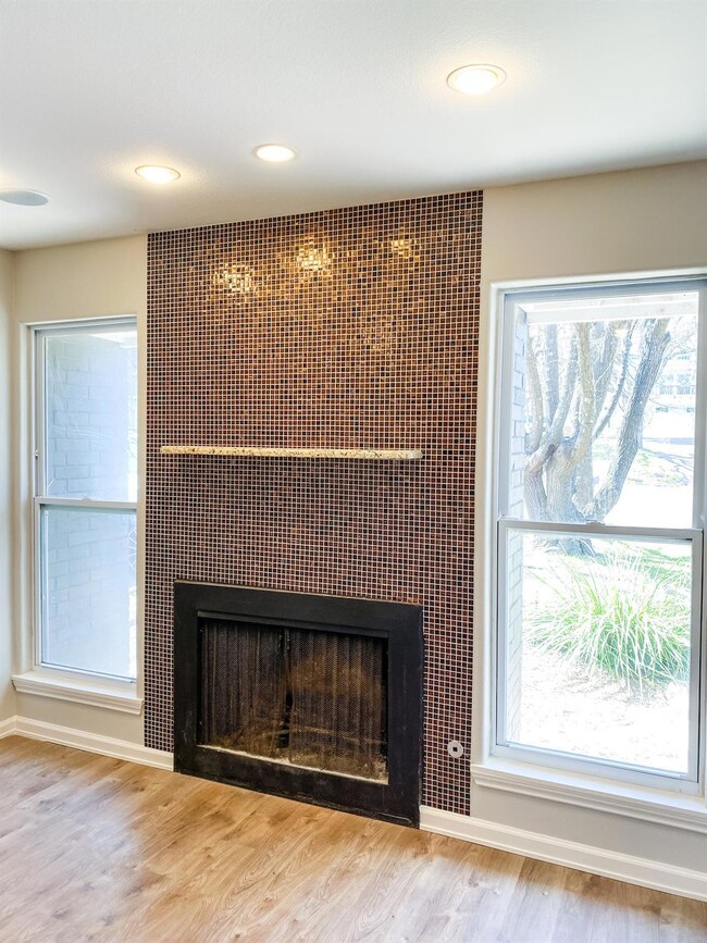 Detailed view of a fireplace, wood finished floor