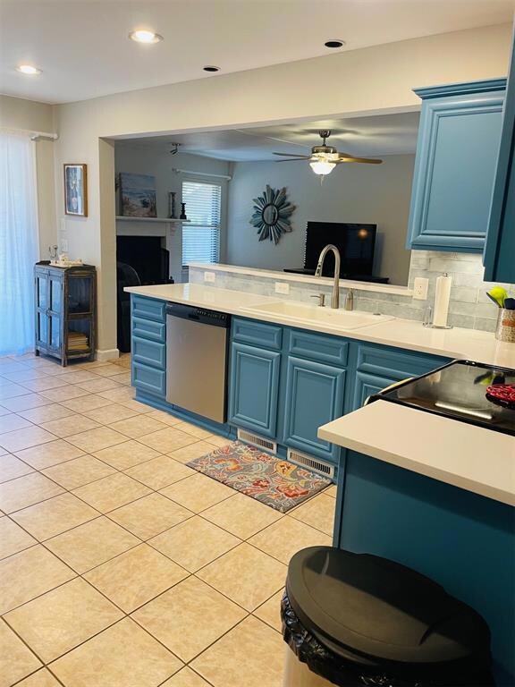 Kitchen featuring tasteful backsplash, blue cabine