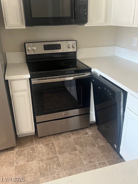Kitchen with stainless steel electric stove, dishw