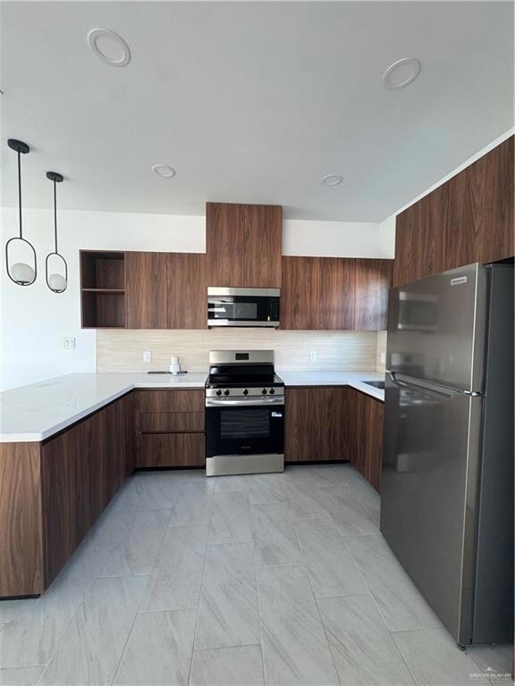 Kitchen featuring fridge, stainless steel stove, modern cabinets, a peninsula, and open shelves