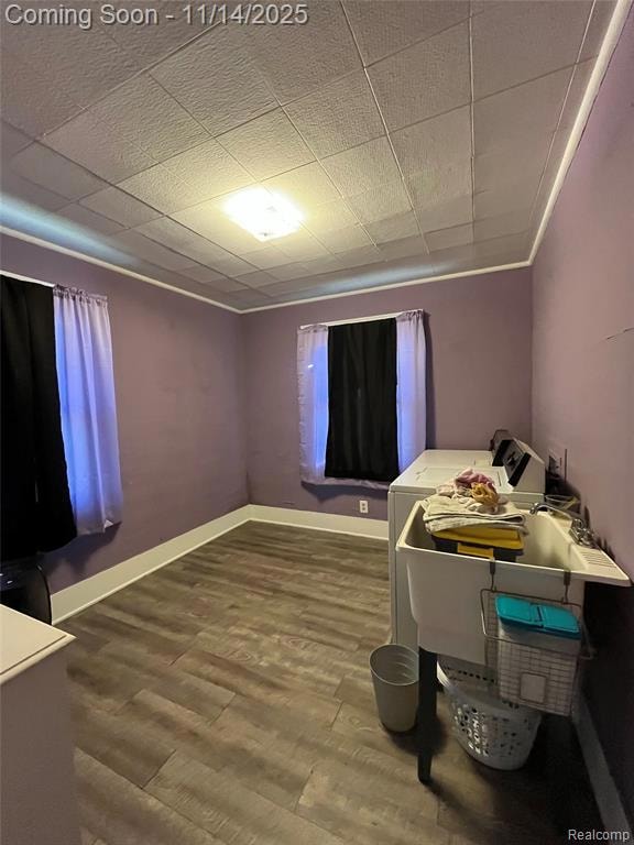 Bedroom featuring dark wood-style flooring and washer / dryer
