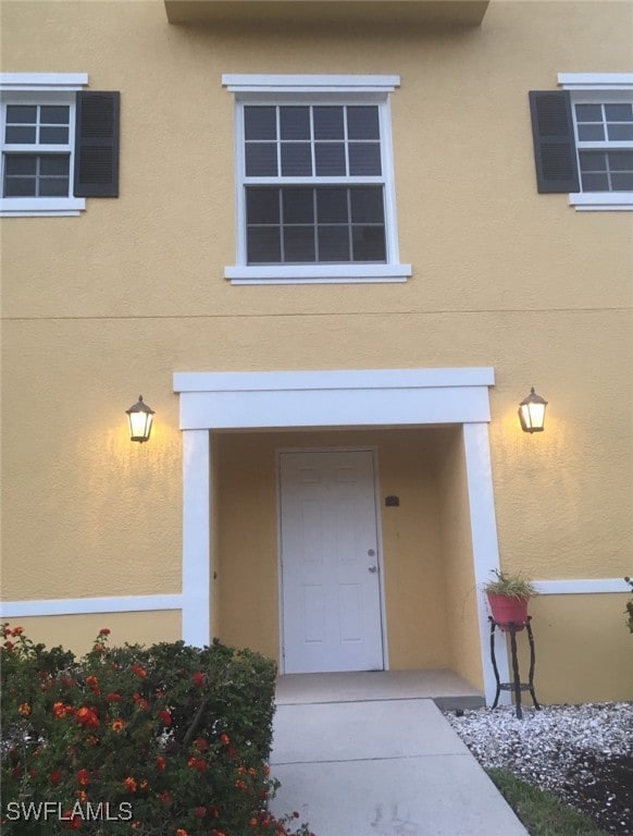 Property entrance featuring stucco siding