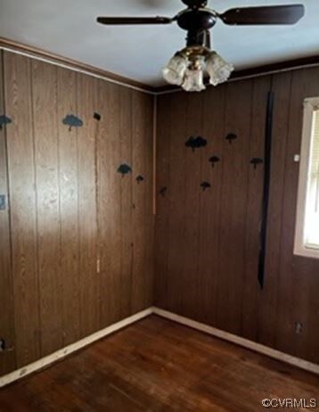 Bedroom with hardwood flooring and ceiling fan.