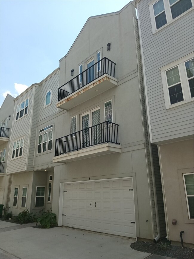 Front of home with the double balconies.